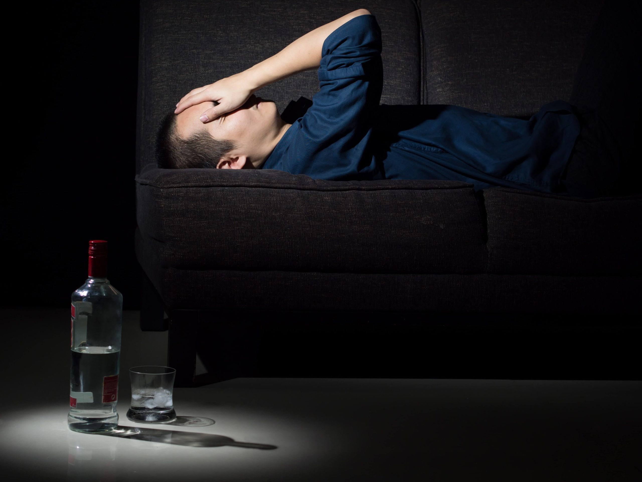 man struggling with the physical effects of alcohol abuse