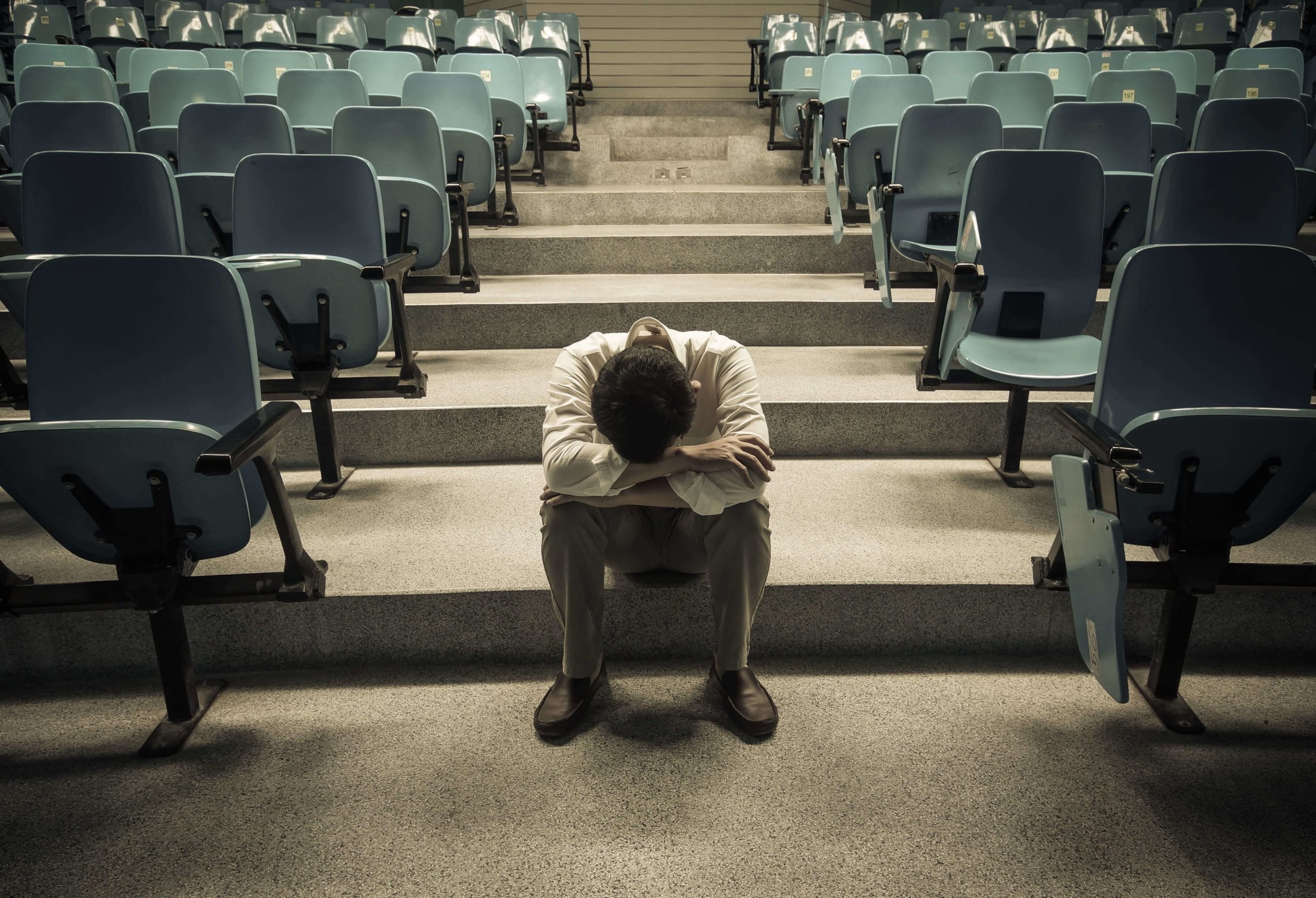 depressed college student in empty classroom