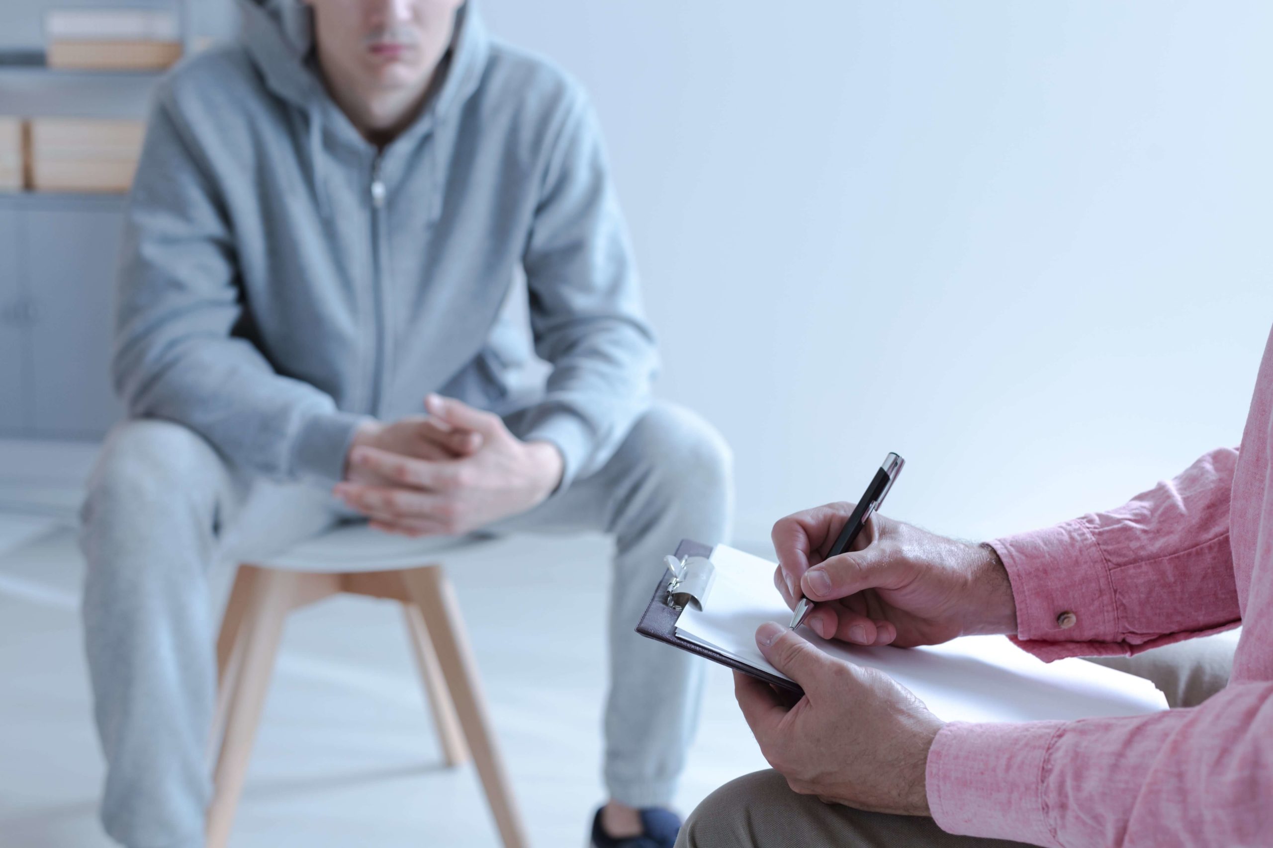 therapist interviewing young man for rehab