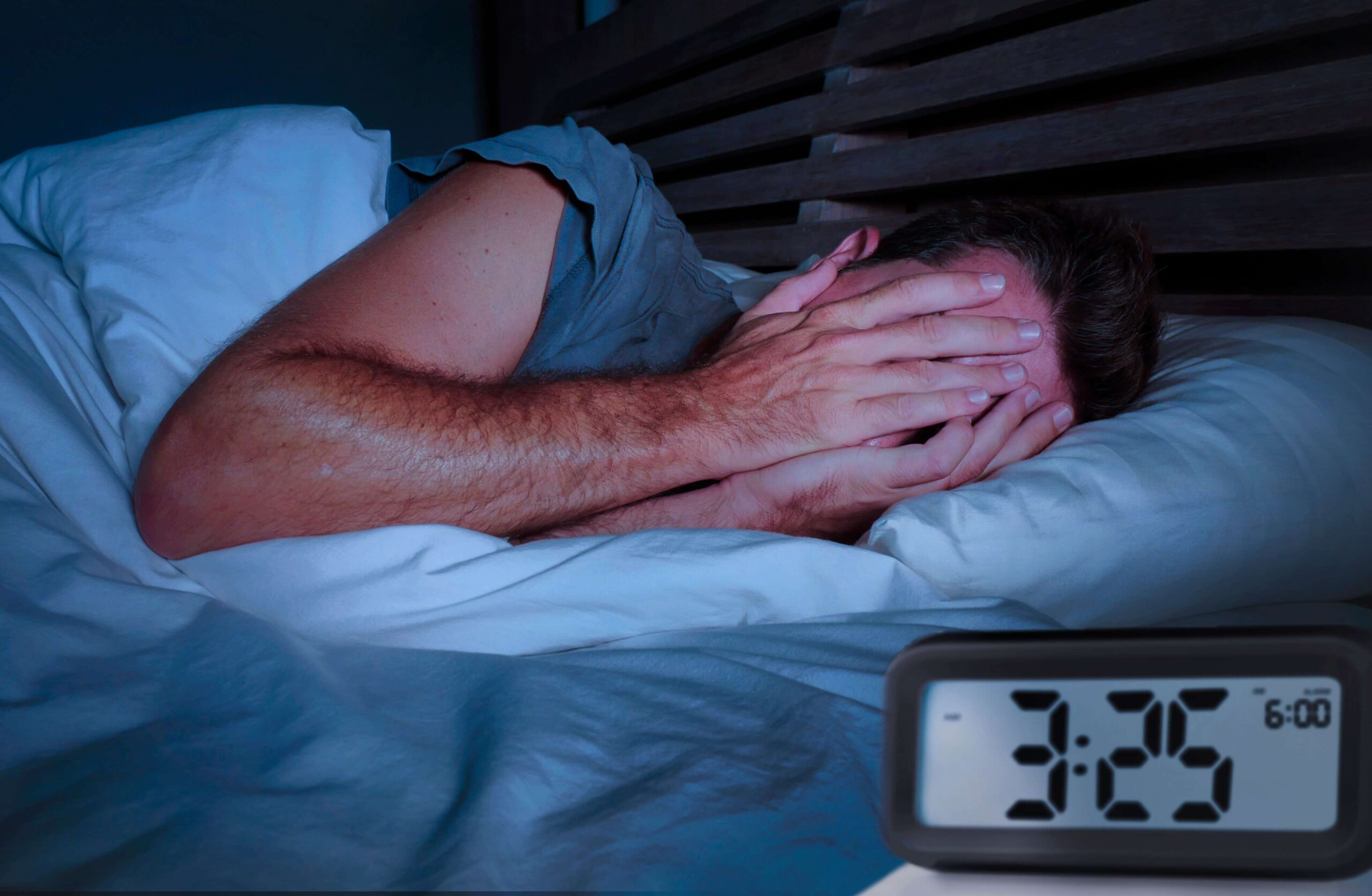 man in bed suffering from the sleep disorder insomnia