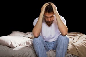 depressed man struggling with insomnia